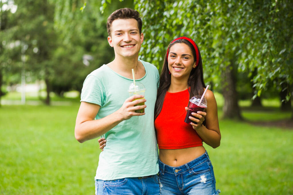 Fit couple drinking juice